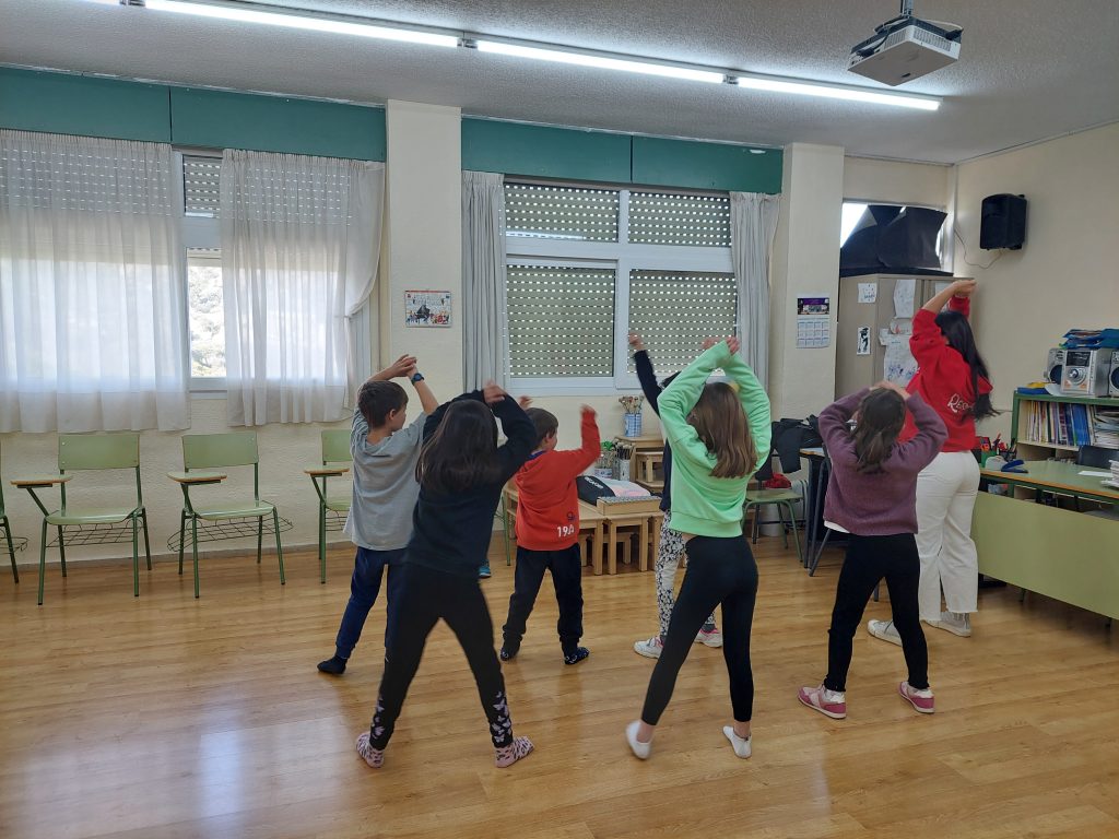 niñas bailando con monitora en salón multiusos